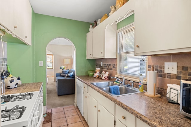 4104 1st St, Des Moines, IA 50313 - kitchen with white appliances, arched walkways, healthy amount of natural light, and white cabinets