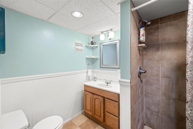 4104 1st St, Des Moines, IA 50313 - bathroom with a wainscoted wall, tiled shower, vanity, and a paneled ceiling