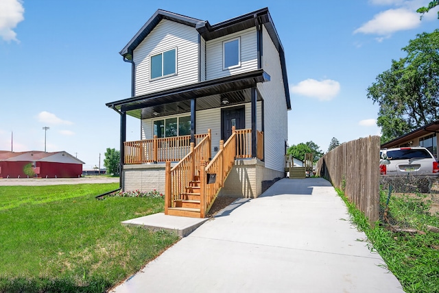 1218 Mccormick St, Des Moines, IA 50316 - view of front of home featuring covered porch, a front yard, and driveway