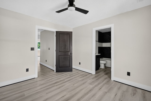 1218 Mccormick St, Des Moines, IA 50316 - unfurnished bedroom featuring light wood finished floors, ensuite bath, and a ceiling fan