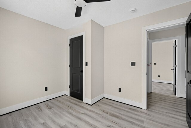 1218 Mccormick St, Des Moines, IA 50316 - unfurnished bedroom with light wood-type flooring and ceiling fan