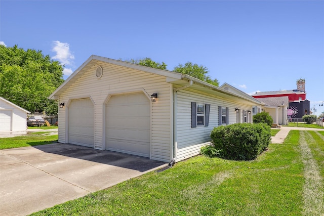 204 N Gaines St, Stuart, IA 50250 - view of property exterior featuring a garage and a yard