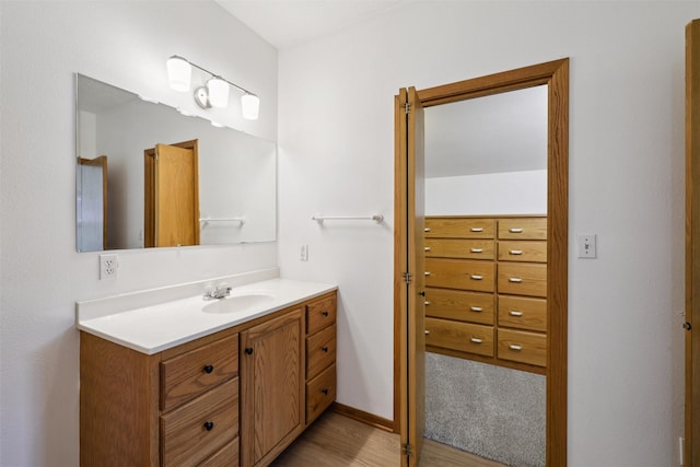 204 N Gaines St, Stuart, IA 50250 - bathroom with vanity and wood finished floors
