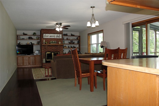 311 W View Dr, Osceola, IA 50213 - dining space with a ceiling fan, dark wood-type flooring, and a fireplace