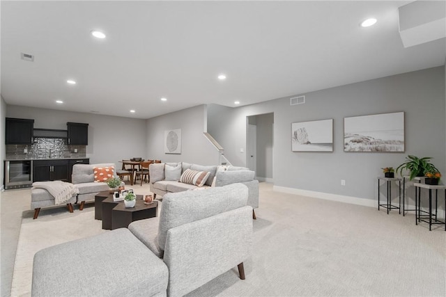 living room featuring wine cooler and light carpet