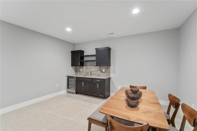 dining room featuring sink and wine cooler