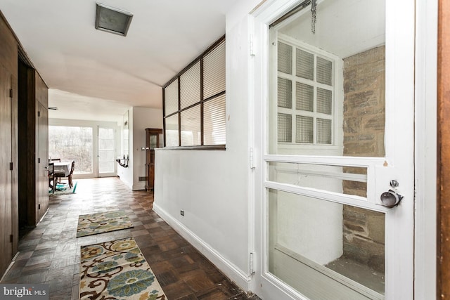 corridor featuring dark parquet flooring