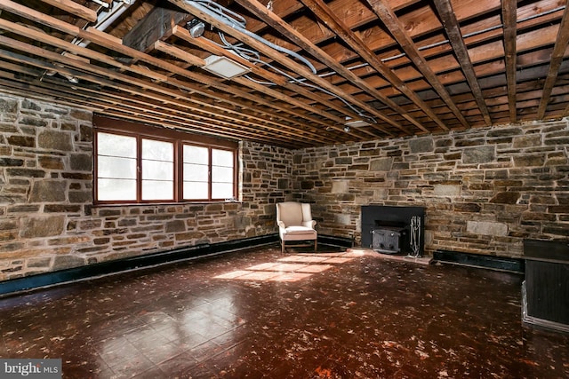 unfurnished room featuring a wood stove