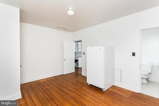 empty room with hardwood / wood-style flooring