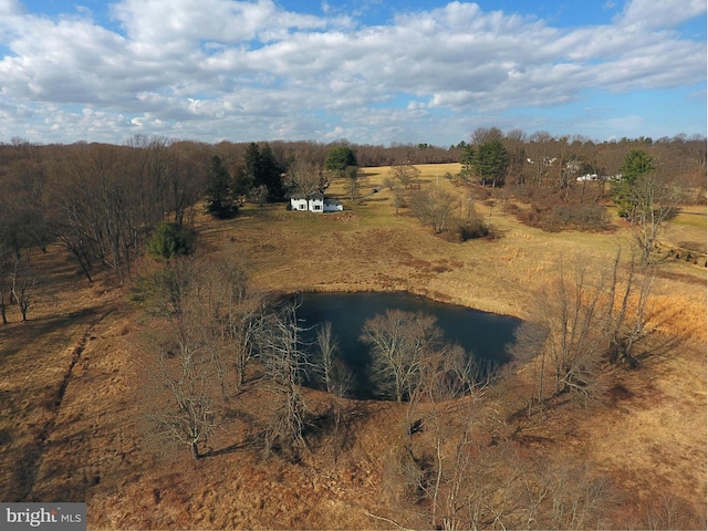 birds eye view of property featuring a water view and a rural view