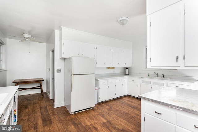 kitchen featuring white cabinets, dark hardwood / wood-style floors, white refrigerator, and ceiling fan