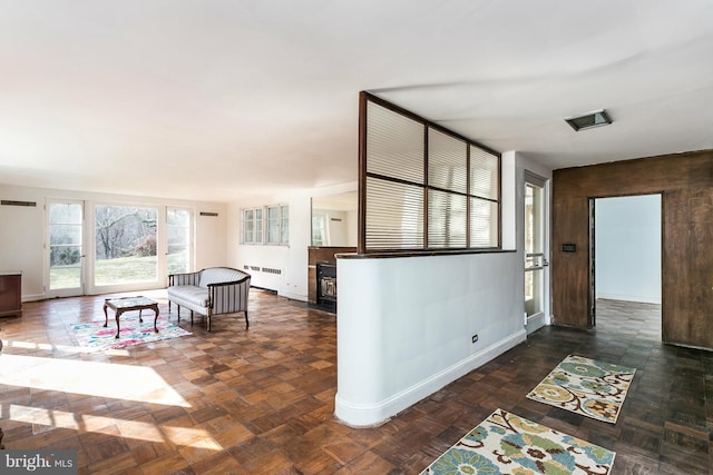 living room featuring radiator heating unit and dark parquet floors