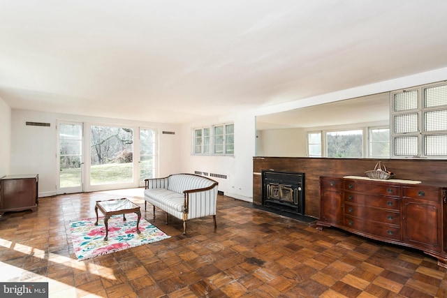 living room featuring dark parquet flooring and radiator