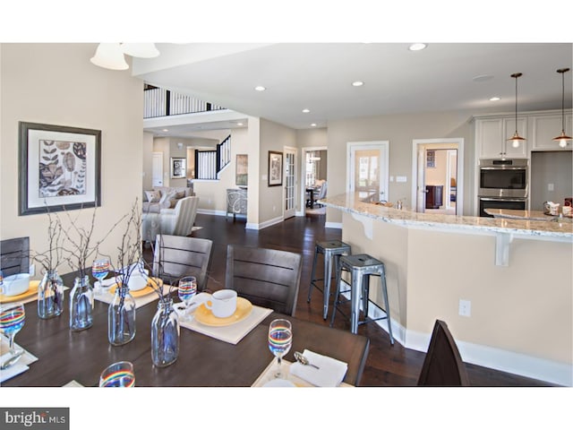 dining space with dark hardwood / wood-style flooring