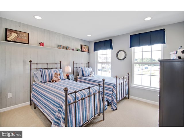 bedroom with multiple windows and light carpet