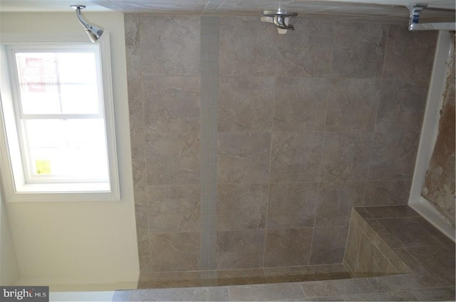 bathroom with a tile shower