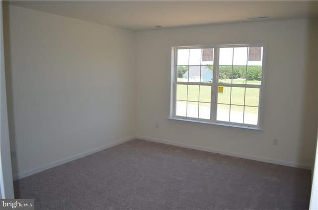 empty room with dark colored carpet