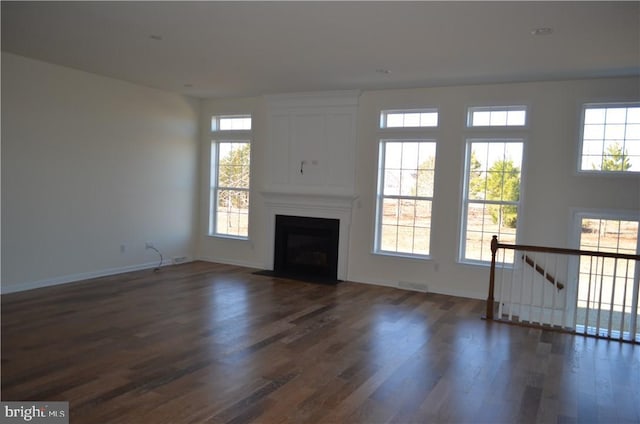 unfurnished living room with dark hardwood / wood-style floors