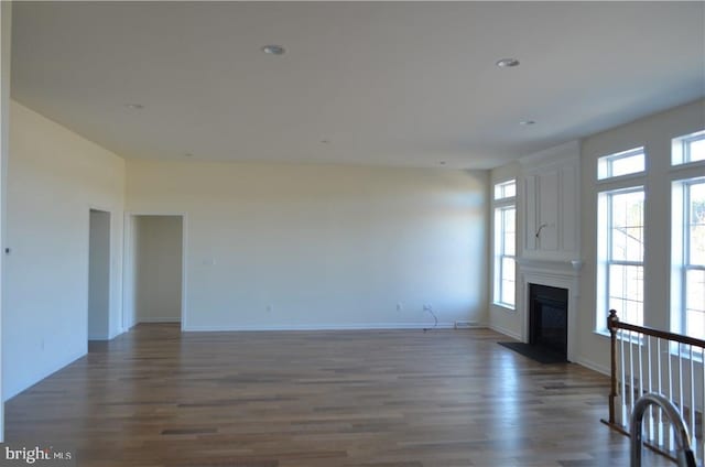 unfurnished living room with dark hardwood / wood-style flooring