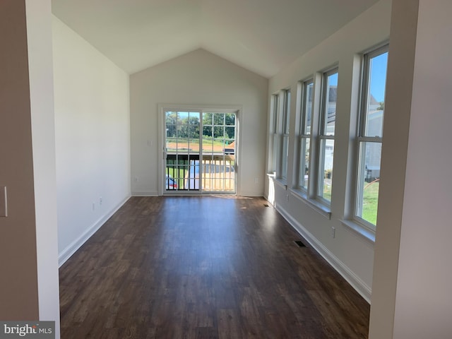 unfurnished room featuring dark hardwood / wood-style flooring and lofted ceiling