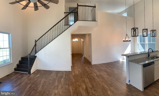 interior space featuring ceiling fan, dark hardwood / wood-style flooring, sink, and high vaulted ceiling