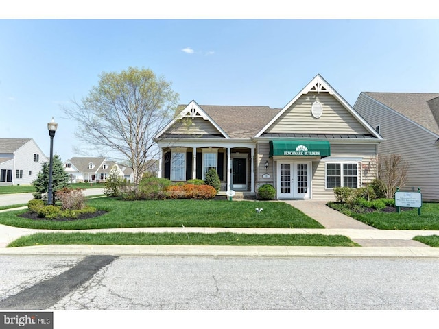 view of front of property with a front lawn and french doors