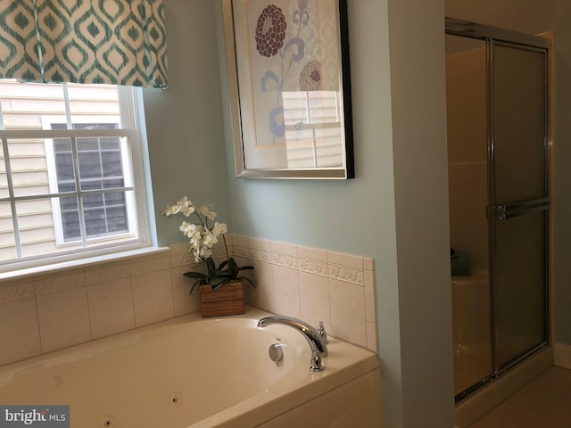 bathroom featuring shower with separate bathtub