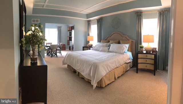 carpeted bedroom featuring multiple windows