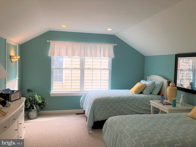 bedroom with vaulted ceiling and light colored carpet