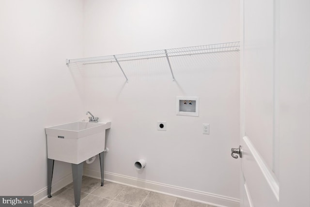 clothes washing area with hookup for a washing machine, light tile patterned floors, and electric dryer hookup