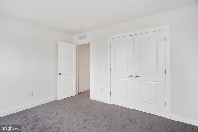 unfurnished bedroom with carpet floors and a closet