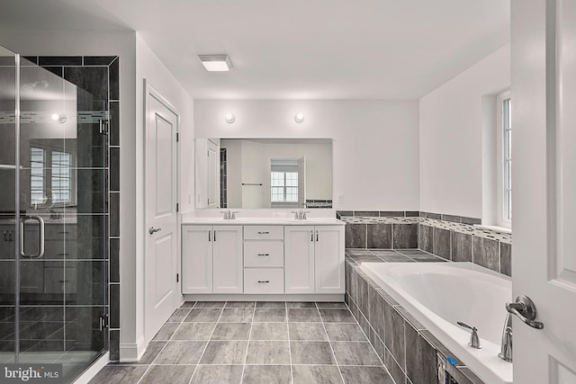 bathroom featuring vanity and independent shower and bath