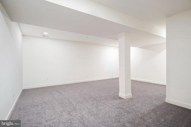 basement with dark colored carpet