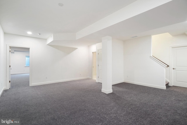 basement featuring dark colored carpet