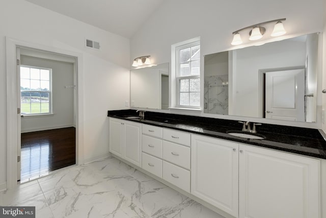 bathroom with hardwood / wood-style floors, vanity, lofted ceiling, and walk in shower