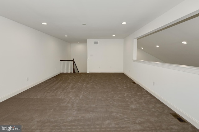 empty room featuring dark colored carpet