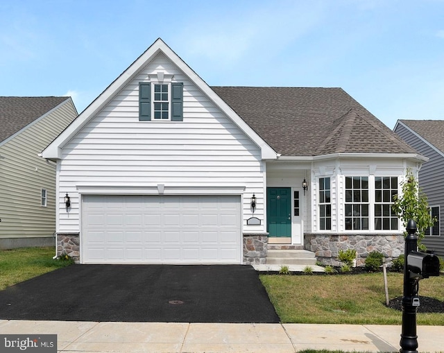 view of front of property with a garage and a front lawn