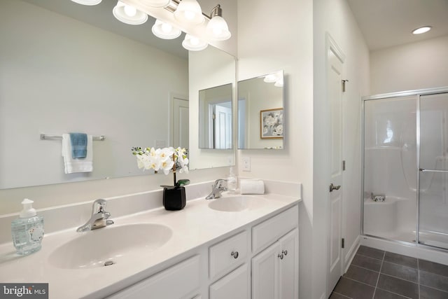 bathroom with tile patterned flooring, vanity, and a shower with shower door