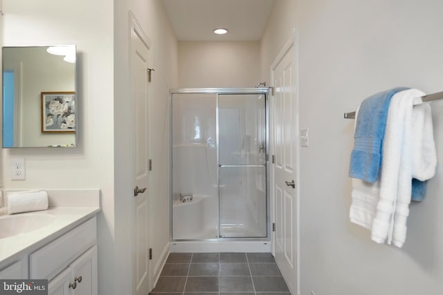 bathroom with vanity, a shower with door, and tile patterned floors