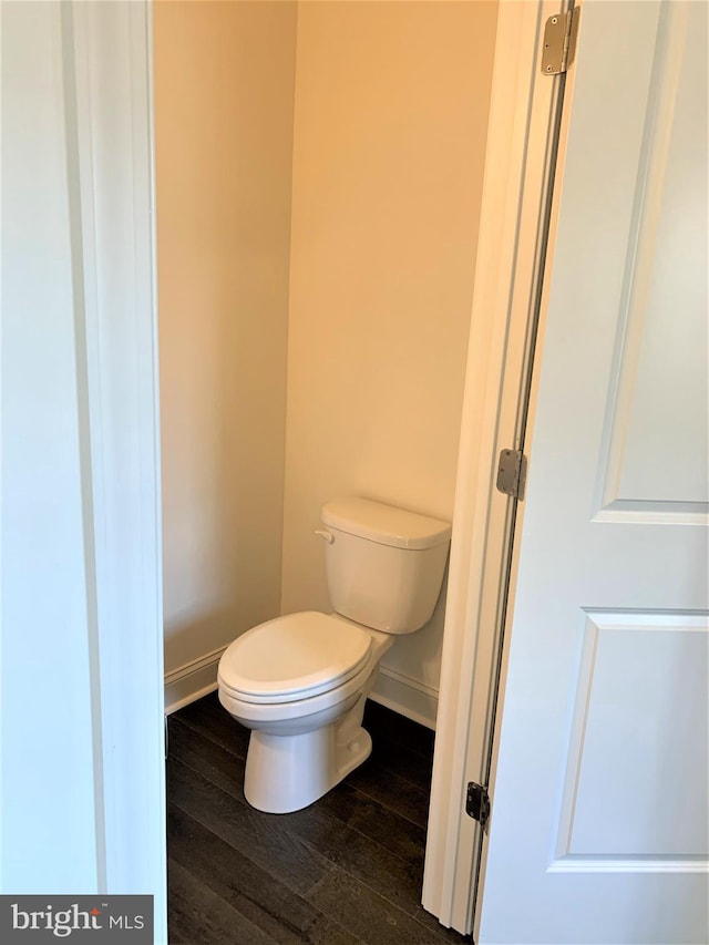 bathroom with hardwood / wood-style flooring and toilet