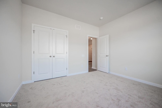 unfurnished bedroom featuring a closet and carpet floors