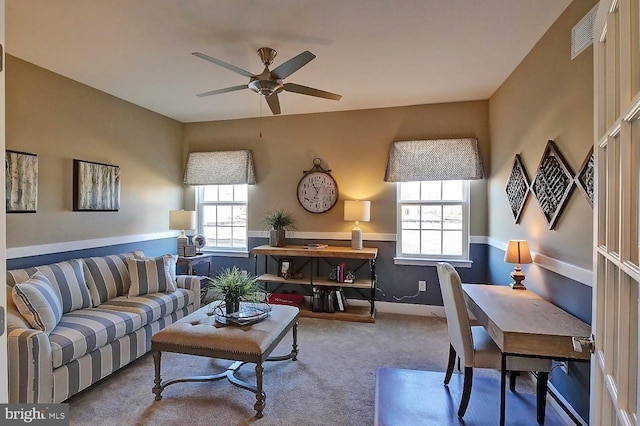 carpeted living room featuring ceiling fan