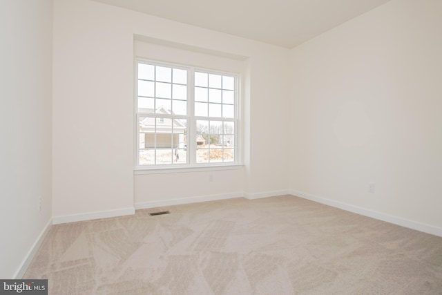 unfurnished room with light carpet