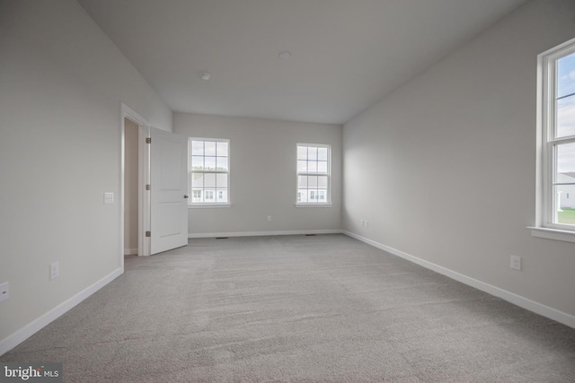 carpeted empty room with a wealth of natural light