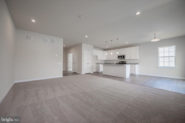 unfurnished living room with hardwood / wood-style floors