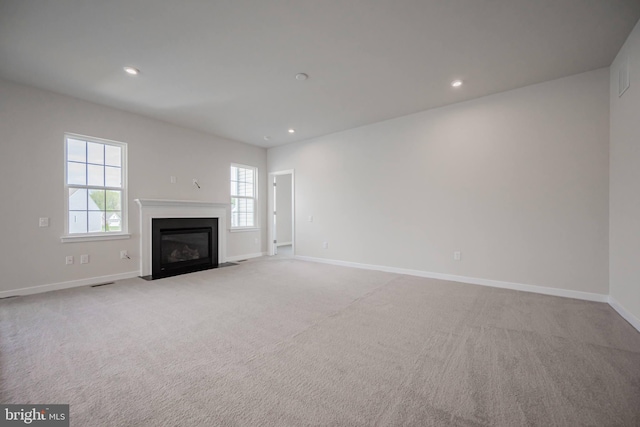 unfurnished living room with light colored carpet