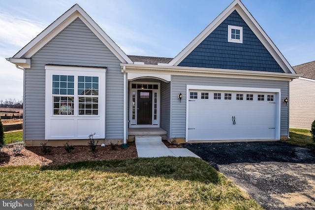 view of front facade with a front yard and a garage