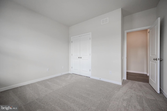 unfurnished bedroom with carpet and a closet