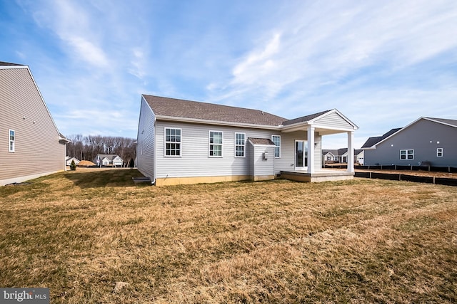 back of property with a lawn