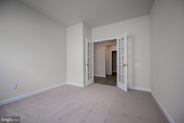 spare room featuring french doors and carpet floors